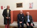 Roland Saam, Thomas Coughlin, and Charles Turner with Maxwell's equations plaque, Kings College, London