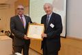 Mr. Uzia Galil receives the Certificate of Appreciation from Region 8 Director Costas Stasopoulos