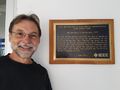 Brian Berg, R6 Milestone Coordinator, with Invention of Holography plaque at Imperial College, London